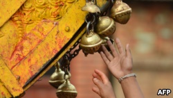 FILE - Nepalese people ring bells during celebrations for the Nepalese New Year or 