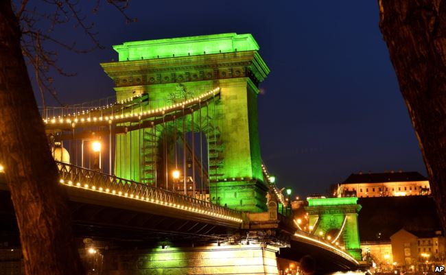 The Chain Bridge is illuminated in green in honor of St. Patrick's Day in Budapest, Hungary, Friday, March 17, 2017. (Tibor Illyes/MTI via AP)