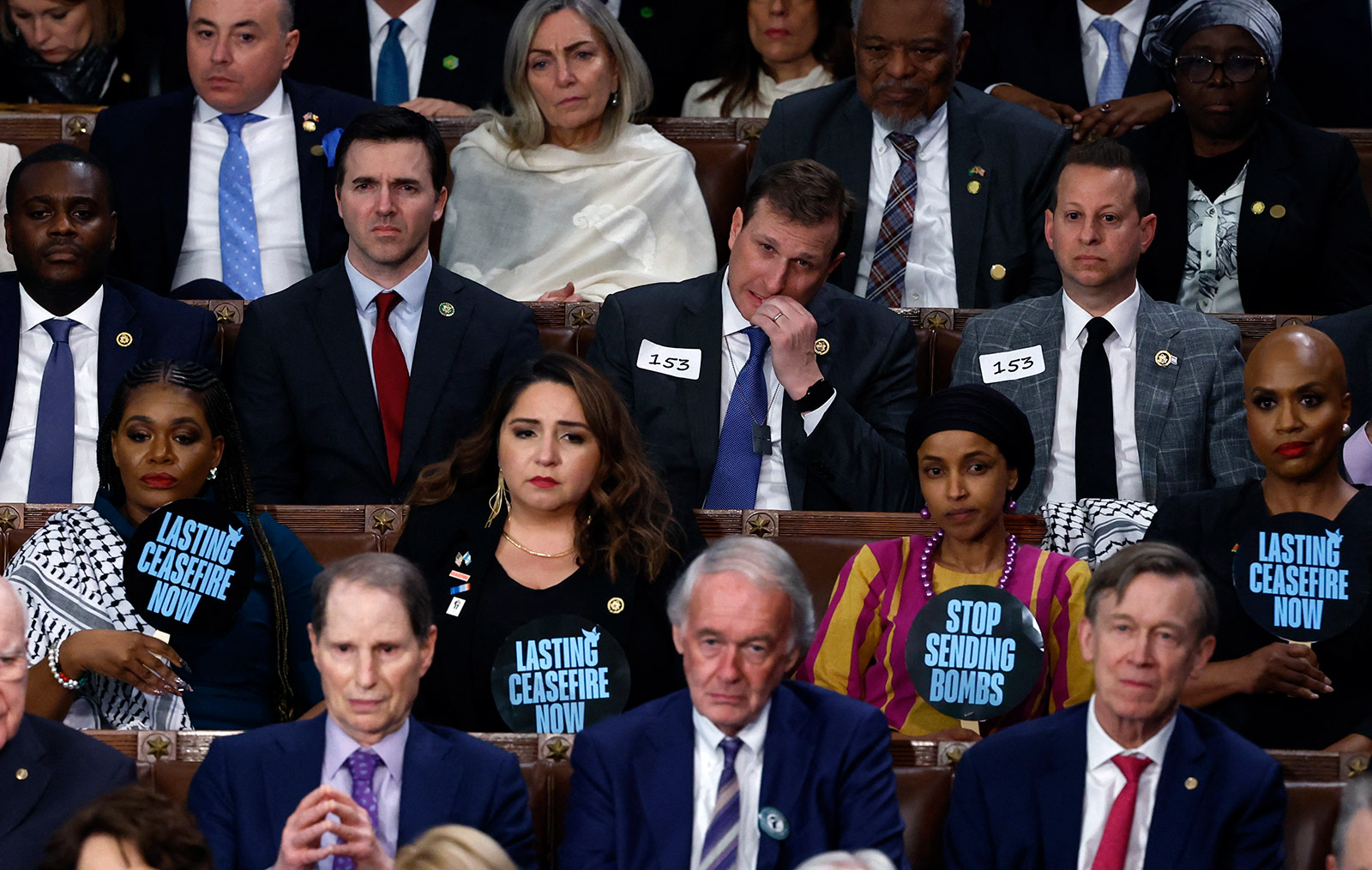 Members of Congress hold signs calling for a ceasefire in the ongoing conflict between Israel and Hamas.