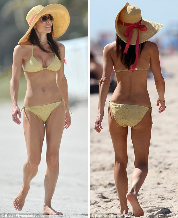 Relaxed The 41-year-old former Real Housewives of New York star strolled alongside the shore pairing her tiny suit with a large floppy hat 