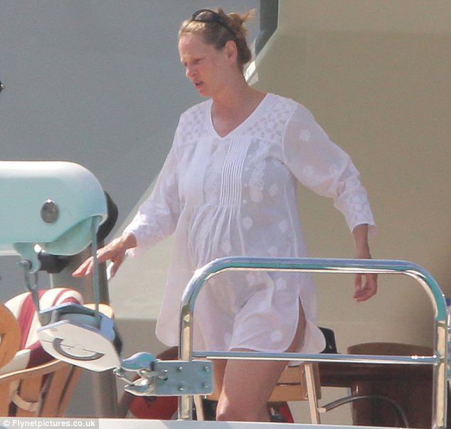 Covering up: Uma wore a white smock dress when she wasn't in her swimwear