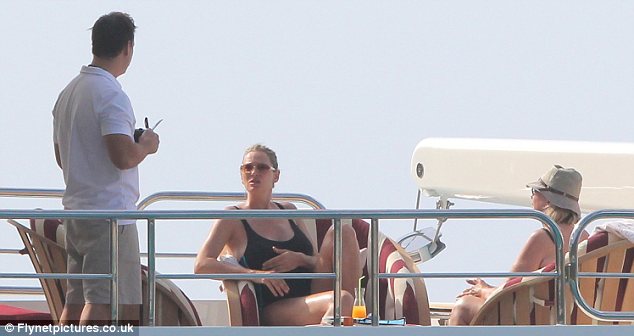 Relaxing: Uma was seen sipping orange juice on deck as she soaked up some sunshine