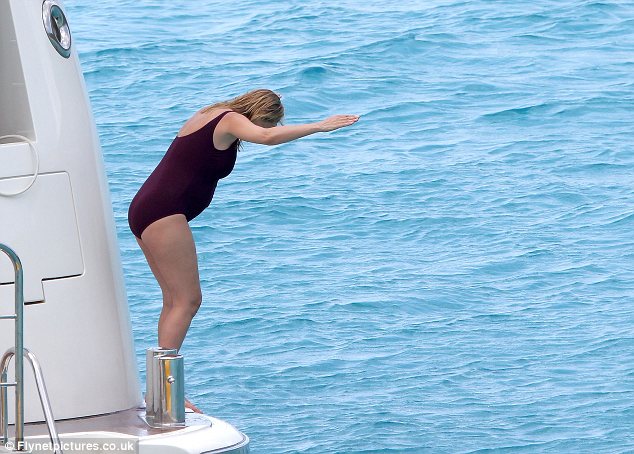 Ready to jump: Uma showed off her swimming skills as she expertly dived off the yacht