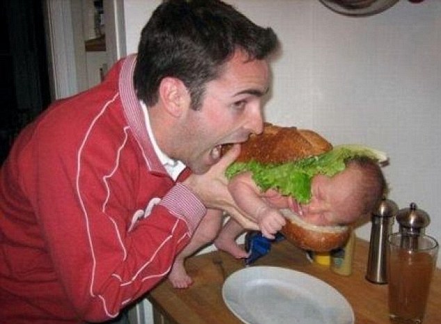 Open wide: A man fooling around pretends to bite into a sandwich with a sleeping baby inside
