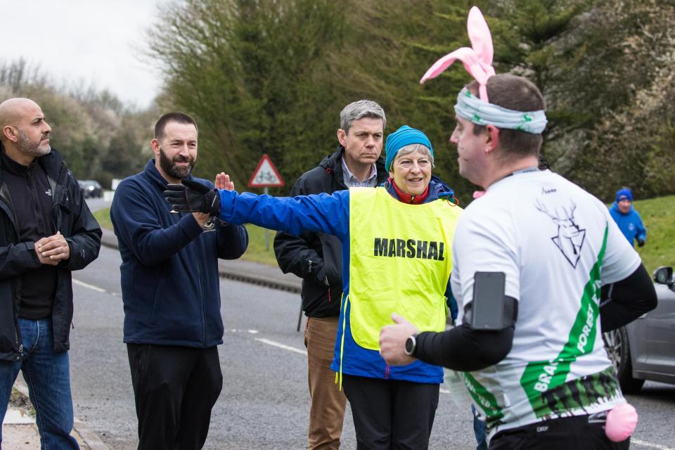 Mrs May didn't bat an eye as she directed a runner with bunny ears