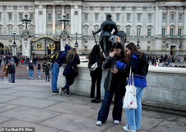 One woman appeared to be wiping a tear from her eyes as she was looking at her phone as the news broke