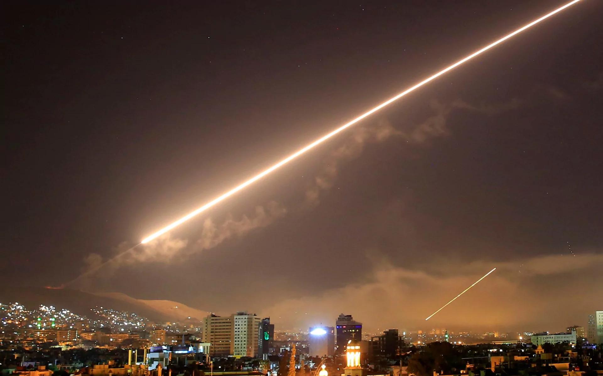 The night's sky lights up over Damascus with surface to air missile fire as the US launches an attack on Syria 