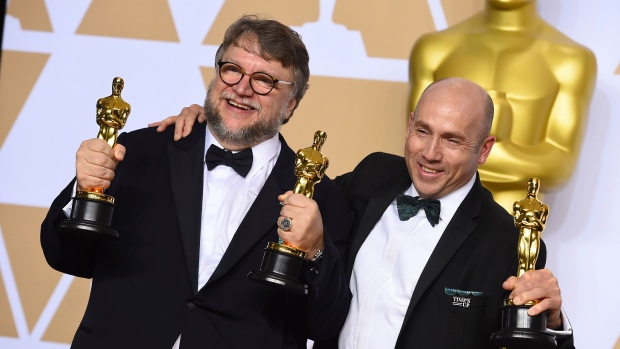 Guillermo del Toro, left, winner of the awards for best director for 