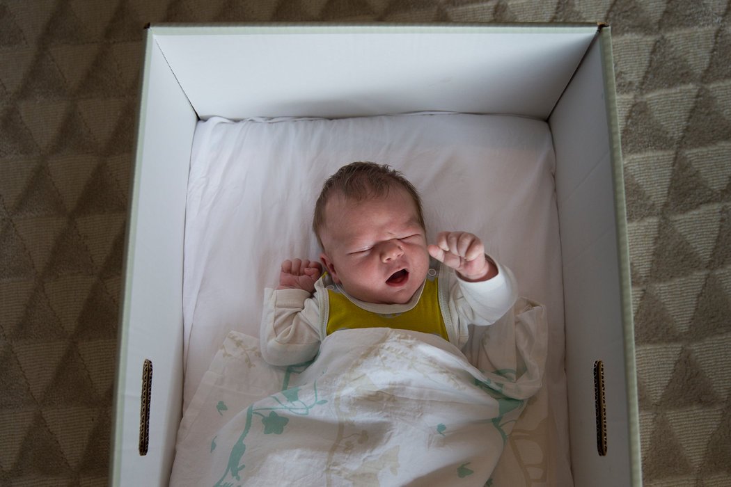 芬兰向准父母发放婴儿箱，图为一个婴儿睡在箱子中。 