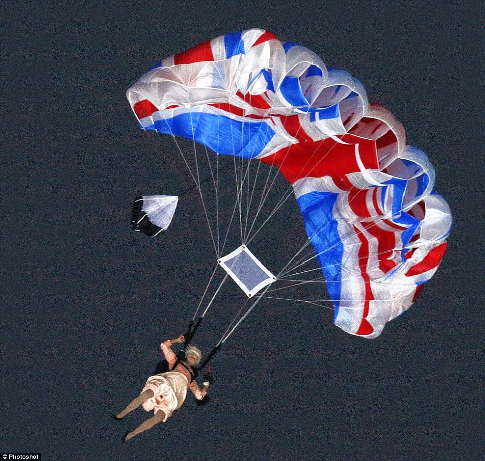 A performer parachutes down during the opening ceremony of the London Olympics