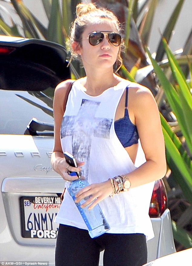 Lingerie flash: Miley flashed quite a lot of her blue bra last week as she left the gym in a sleeveless white top 