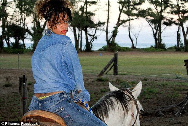 In her denims: Rihanna proves she had other items of clothing in her wardrobe besides bikinis as she took a horse ride