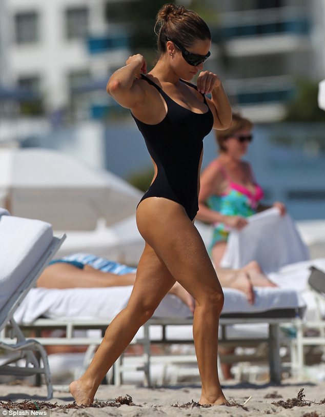 Beach babe: Lola teamed her sexy swimwear with sunglasses and tied her locks into a bun