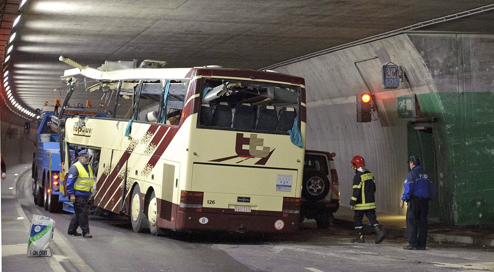 Head-on collision: As the coach is dragged away by a tow truck, the wall it careered into can be clearly seen