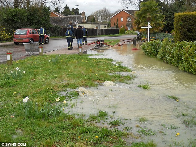 A burst water main floods a street in Cambridge last week. The Environment Agency has called on businesses to save water through efficiency and fixing leaks