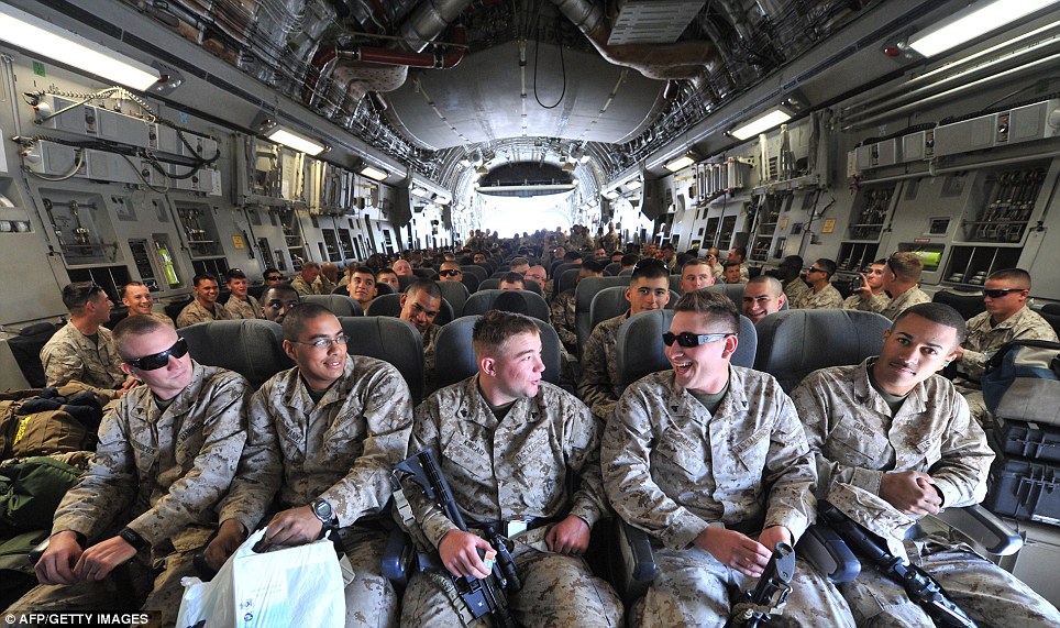 US servicemen sit inside of a plane before their departure to Afghanistan from the US transit center Manas