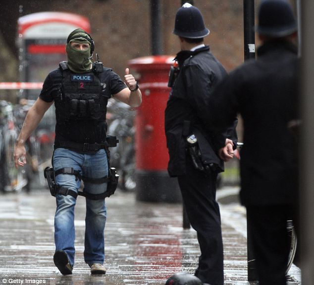 Dixon of Dock Green... balaclava: A member of Scotland Yard's firearms unit gives the thumbs up after arriving on the scene of yesterday's hostage crisis