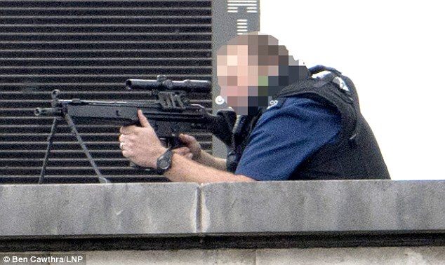 Taking aim: A police marksman has the hostage taker in his sights