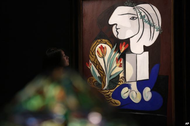 Pablo Picasso is one of the most famous Cubist painters. Here, a woman looks at his painting titled "Nature Morte Aux Tulipes" at an auction in Hong Kong, Oct. 2012.